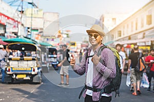 Young Asian traveling man walking in Khaosan Road walking street at Bangkok
