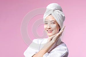 Young asian woman applying facial skincare face cream, cosmetic moisturiser on healthy natural skin make up face. Portrait glowing