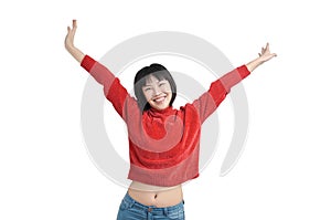 Young asian woman with arms raised and laughing wearing red sweater, isolated.