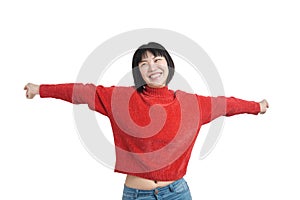 Young asian woman with arms raised and laughing wearing red sweater, isolated.