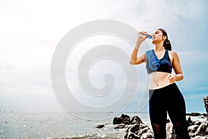 Young Asian woman beautiful athlete drinking water