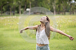 Young Asian woman breathe fresh air in park