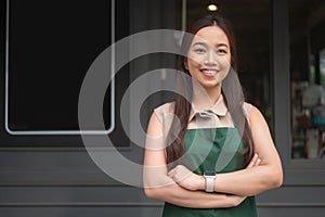 Young Asian woman cafe owner entrepreneur smiling in coffee shop, small business concept