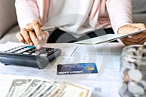 Young Asian woman Calculating monthly expense at her desk. Home saving concept. Financial and Installment payment concept.