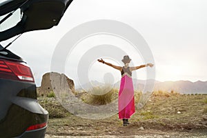 Young asian woman car traveler enjoying the morning sunlight on the road