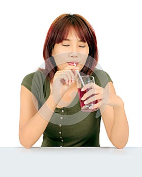 Young asian woman with a cglass of grape juice