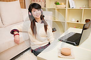 Young asian woman chatting with laptop