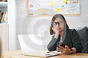 Young asian woman checking reading smart phone repetitious bored news