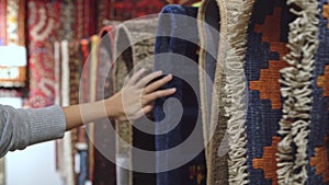 Young Asian woman choosing interesting fabric, teenager female feeling happy shopping in clothing store. Women shopping fabric