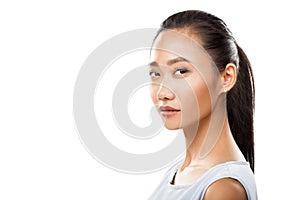 Young asian woman closeup turned head and looking at camera