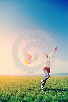 Young asian woman with colored balloons