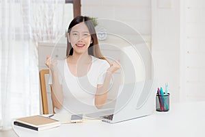 Young asian woman confident working at home with laptop computer and thinking idea for planning.