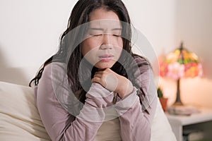 Young Asian woman depressed - young beautiful and sad  Chinese girl on bed with pillow feeling unhappy and broken heart suffering