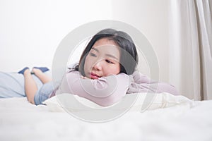 Young Asian woman depressed - young beautiful and sad  Japanese girl on bed with pillow feeling unhappy and broken heart suffering