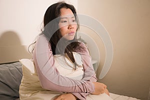 Young Asian woman depressed - young beautiful and sad  Korean girl on bed with pillow feeling unhappy and broken heart suffering