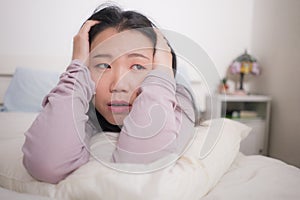 Young Asian woman depressed - young beautiful and sad  Korean girl on bed with pillow feeling unhappy and broken heart suffering