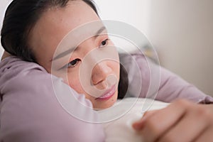 Young Asian woman depressed - young beautiful and sad  Korean girl on bed with pillow feeling unhappy and broken heart suffering