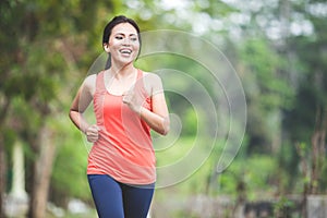 Young asian woman doing excercise outdoor in a park, jogging