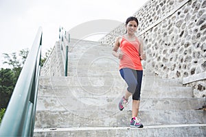 Young asian woman doing excercise outdoor in a park, jogging up