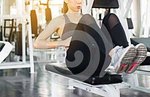 Young asian woman doing situp or crunches in gym,Female exercise muscular her stomach