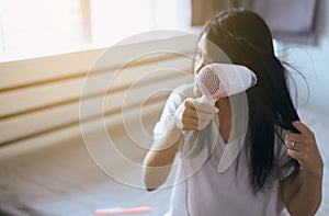 Young asian woman drying hair with towel,Female drying her long hair with dryer