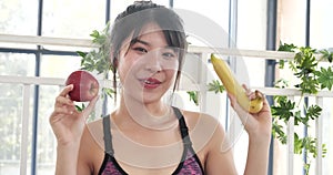 Young asian woman eating Apple Healthy. Girl workout holding organic apple fruit healthy lifestyle. Wellness Asian women eat red a
