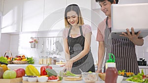 Young asian woman eating sandwich breakfast making roasted bread on electric toaster