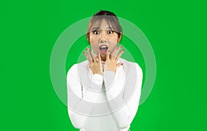 Young Asian woman eith surprised face isolated on green screen