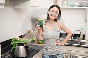 Young asian woman enjoy healthy vegetarian smoothie for weight l