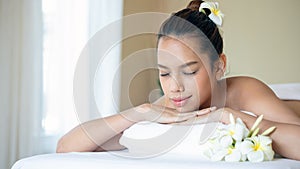 Young Asian Woman Enjoying Spa Treatment on a White Bed with copy space Luxury Spa Day