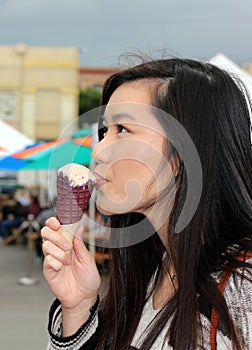 Young Asian Woman Enjoys an Ice Cream Cone Indulgence