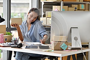 Young Asian woman entrepreneur/ Business owner working with computer at home