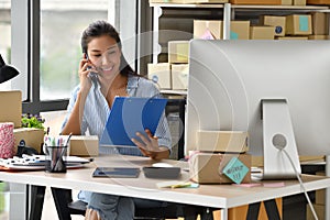 Young Asian woman entrepreneur/ Business owner working with computer at home