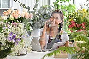 Young Asian woman entrepreneur/shop owner/ florist of a small flower shop business