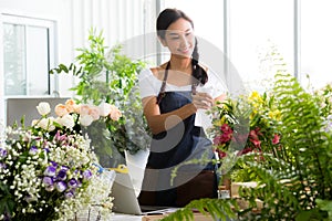 Young Asian woman entrepreneur/shop owner/ florist of a small flower shop business