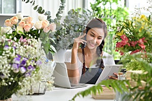 Young Asian woman entrepreneur/shop owner/ florist of a small flower shop business