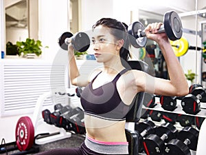 Young asian woman exercising working out in gym