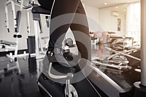 Young asian woman exercising on the xtrainer machines