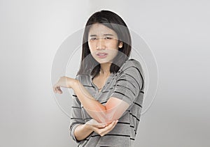 Young asian woman feel elbow bones injury