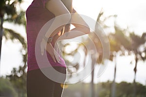 Young asian woman feel pain on her back and hip while exercising, health care concept