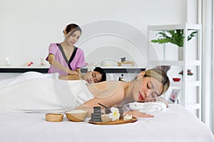 Young asian woman feeling happy and relax during massage. Attractive beautiful girl lying on massage table, getting physiotherapy