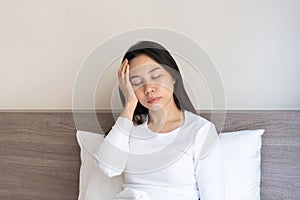 Young Asian woman feeling sick with cold and fever at home
