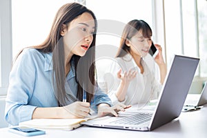Young asian woman focusing on getting work done