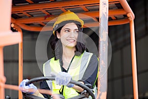 Young asian woman is foreman driving forklift at distribution warehouse, engineer working and shipping container.