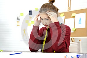 Young asian woman with frustrated expression while working at fashion design studio desk, people emotional and office lifestyle