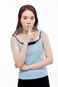 Young Asian woman gesture dont' make sound.