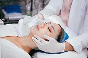 Young Asian woman getting IPL and laser treatment by beautician