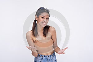 A young asian woman gives an explanation, discussing with eagerness. Isolated on a white background