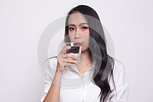 Young Asian woman with a glass of drinking water