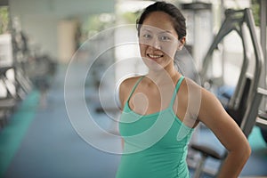 Young asian woman in gym keeping fit